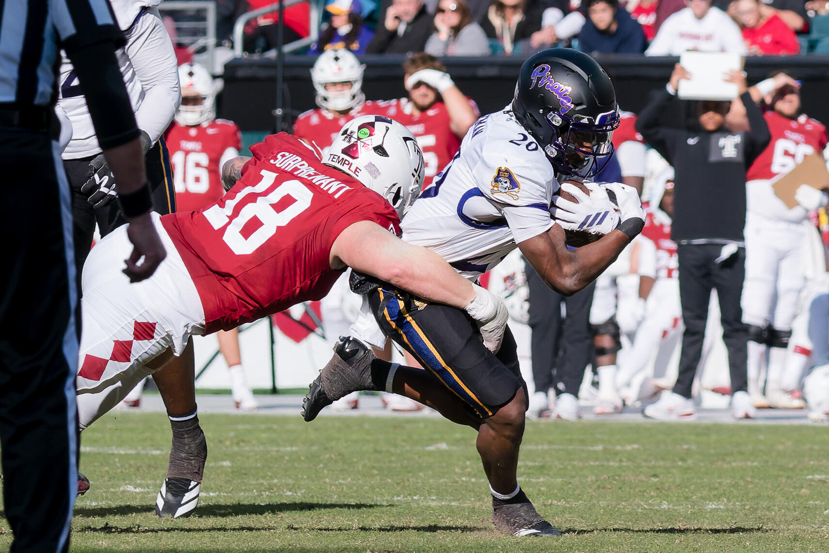 PHILADELPHIA, PA - Temple defensive back Tyler Surprenant (18) tackles East Carolina running back TJ Engleman (20) during a 2025 NCAA football game at Lincoln Financial Field.